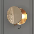 Gold Metallic Wall Lamp With Radial Design Mounted On Gray Wall