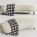 Stylish Beige Curved Sofa Bench With Black And White Plaid Blanket And Wooden Legs
