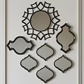 Ornate Decorative Mirrors With Various Geometric Shapes And Black Frames On White Wall
