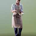 Woman in Brown Apron with Bow Holding Spatula Preparing Meal in Kitchen
