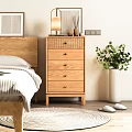 Wooden Chest of Drawers in Bedroom with Bedhead Table Lamp and Green Plant