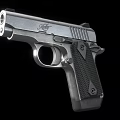 Stainless Steel Pistol With Textured Black Grip And Sleek Design Features Trigger And Barrel