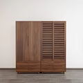 Modern Wooden Walnut Wardrobe with Smooth Panel Doors Louvered Front and Drawers Near Potted Plant