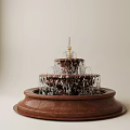Ornamental Three Tiered Garden Fountain With Brown Base Flowing Water And Statue On Top