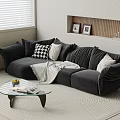Dark Gray Three-Seater Sofa With Plush Cushions Throw Blanket Glass Coffee Table On Round Rug