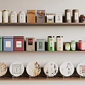 Traditional Tea Sets with Colorful Canisters and Round Tea Cakes on Wooden Shelves