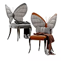Modern Butterfly Shaped Dining Chairs With Gray Brown Upholstery And Decorative Throw Blankets