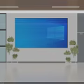 Public Facility Lobby Featuring Large Blue Screen Display Green Plants And Glass Doors