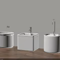 White Bathroom Washbasins Against Light Colored Wall With Faucets And Wooden Floor