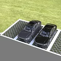 Two Black Cars Parked on Grid Pattern Parking Lot With Green Grass Background