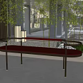 Modern Maroon Sofa Bench With Black Metal Legs Bamboo Plants Stone Pebbles And Large Windows