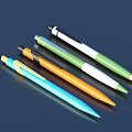 Vibrant Colored Ballpoint Pens in Blue Orange Green White on Dark Background