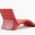 Red Modern Lounge Chair With Sleek Curved Design And Smooth Lines