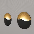 Modern Circular Wall Lamp with Black and Gold Design and Radiant Light Pattern on Wall
