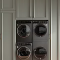 Laundry Room Interior With Gray Cabinets And Stacked Washing Machines