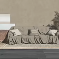 Two-Seater Beige Sofa With Slipcover Pillows Woven Rug And Pampas Grass Vase On Neutral Wall