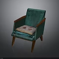 Teal Accent Chair With Wooden Armrests And Legs Featuring Decorative Cushion With Red Patterns