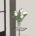 White Tulips And Eucalyptus Leaves In Transparent Striped Vase For Home Decor On Glass Table