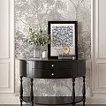 Black Entryway Console Table With Green Plants Framed Art And Candle Decor On Patterned Wallpaper