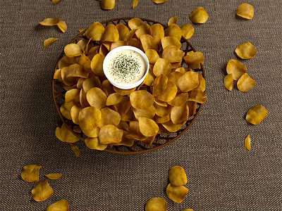 Crispy Potato Chips With Bowl Of Dip In Basket And Scattered Around 3d model