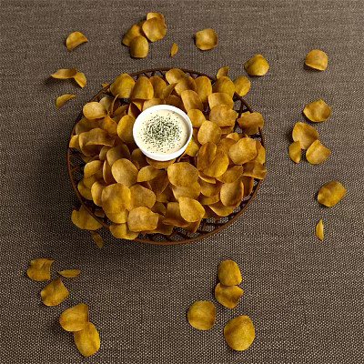 Crispy Potato Chips With Bowl Of Dip In Basket And Scattered Around 3d model