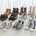 Various Boots Sneakers In Black Brown Gray Beige On Light Marble Floor With White Curtains