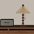 Modern Table Lamp With Pleated Shade And Wooden Base Next To Marshall Radio On Wooden Cabinet