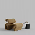 Modern Curved Brown Leisure Chair With Black Side Table And Decorative Books