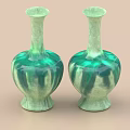 Two Green Ceramic Vases With Tall Neck And Rounded Glossy Body On Beige Background