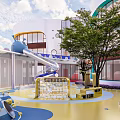Modern School Building With Playground Slide Tree And Colorful Ground