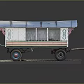 Vintage Model Caravan With Blue Roof Green Pink Stripes And Decorative Patterns On Gravel Base