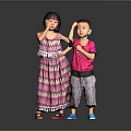 Woman In Colorful Striped Dress Standing With Child In Pink T Shirt Against Gray Background