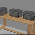 Three Modern Microwaves With Digital Display As Kitchen Appliances On Wooden Table