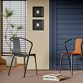 Stylish Black and Orange Dining Chairs with Blue Wall Window Blinds Plant and Books
