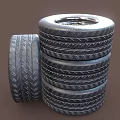 Car Tires Stacked with One Leaning Tire Featuring Metal Wheel Rim