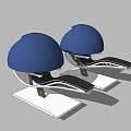 Pair Of Blue Helmets With Black Straps On White Base Stand
