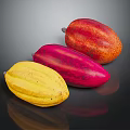 Three Vibrant Cocoa Pods in Yellow Red and Orange Tones on Reflective Black Background