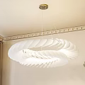 White Layered Leaf Design Chandelier Hanging In Room With Decorative Ceiling Molding Curtains Green Plant