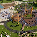 Fun Safe Kids Playground With Climbing Structures Swings Green Lawn And Natural Wooden Elements