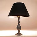 Classic Table Lamp With Black Lampshade And Decorative Metal Base Glowing Softly