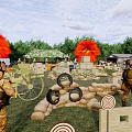Military Personnel Training at Outdoor Shooting Range With Targets Tires and Sandbags