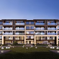 Modern Residential Building Exterior with Balconies Glass Windows Green Lawn and Cherry Blossoms