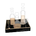 Elegant Ceramic Vessels On Black Tray With Gold Edge And Yellow Liquid Glass Cup
