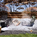 Serene Courtyard Garden With Natural Hot Spring Rocks Lush Trees Greenery And Relaxing Bathing Area