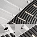 Modern Recessed Downlights And Spotlights Installed In Perforated White And Slat Black Ceilings