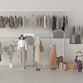 White Clothes Rack with Hanging Clothes Fashion Mannequins Potted Plant Suitcases and Round Decorations