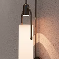Minimalist Modern Wall Sconce With Metal Frame White Shade And Light Shadow On Textured Wall