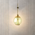Gold Metal Round Glass Pendant Light Against Vertical Striped Light Wall