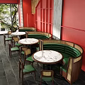 Cozy Restaurant Interior With Red Walls Green Leather Booths Round Marble Tables And Wicker Chairs