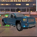 Blue GMC Truck Parked On City Street With High Rise Buildings And Night Lights
